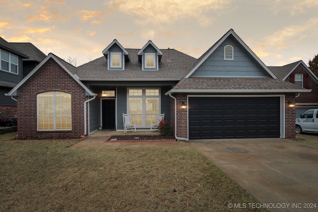 view of front of property featuring a lawn and a garage