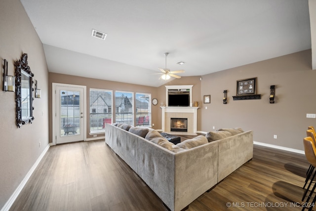 living room with ceiling fan, dark hardwood / wood-style flooring, and a fireplace