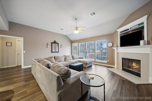 living room with a tile fireplace, ceiling fan, wood-type flooring, and lofted ceiling