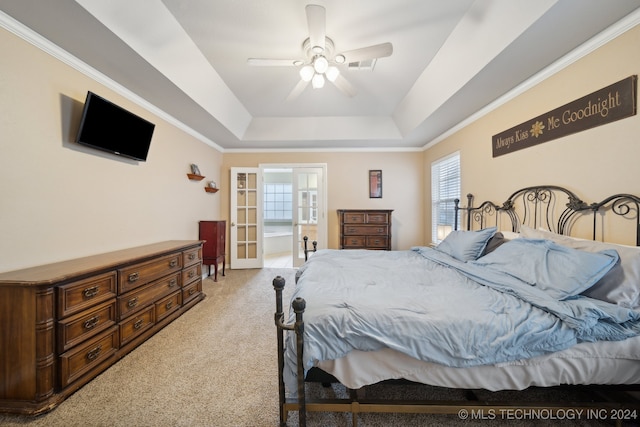 bedroom featuring a raised ceiling, ceiling fan, light colored carpet, and ornamental molding