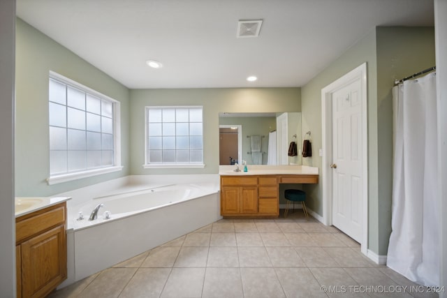 bathroom featuring tile patterned flooring, vanity, and separate shower and tub