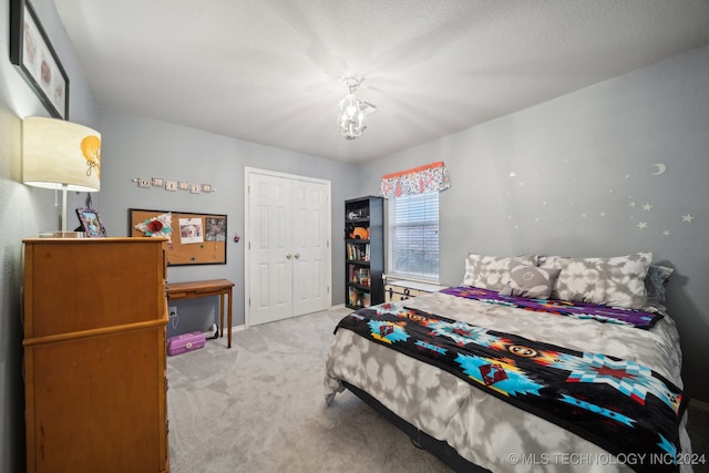 bedroom with light carpet and a closet