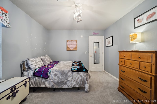 bedroom featuring light carpet