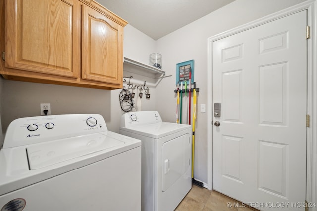 laundry area with cabinets and washer and clothes dryer