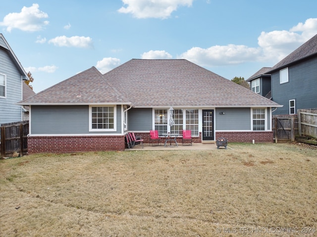 rear view of house with a patio area and a yard