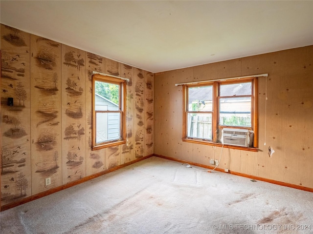 empty room featuring cooling unit and light colored carpet