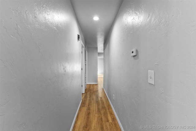 corridor featuring hardwood / wood-style floors