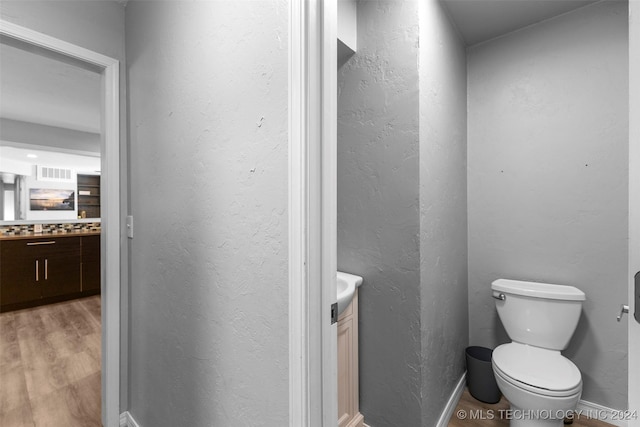 bathroom featuring hardwood / wood-style floors, vanity, and toilet