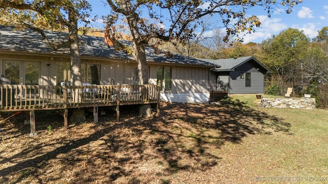 rear view of property featuring a deck