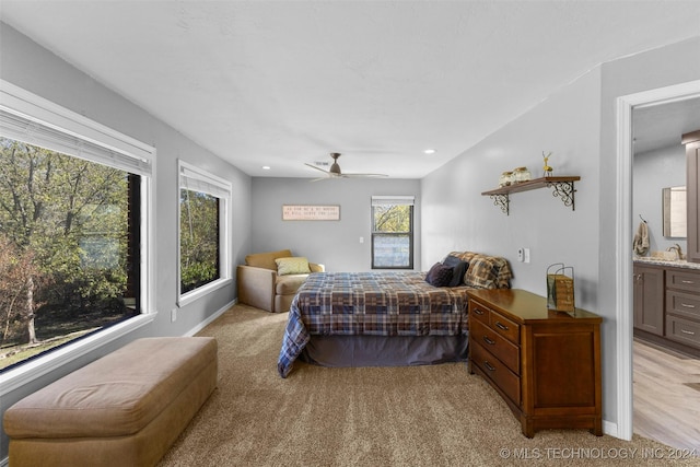 carpeted bedroom featuring connected bathroom, ceiling fan, and sink