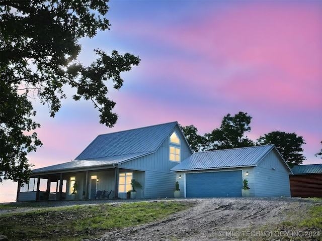 view of front facade featuring covered porch and a garage