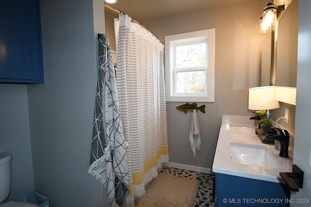 bathroom featuring tile patterned floors, vanity, a shower with shower curtain, and toilet