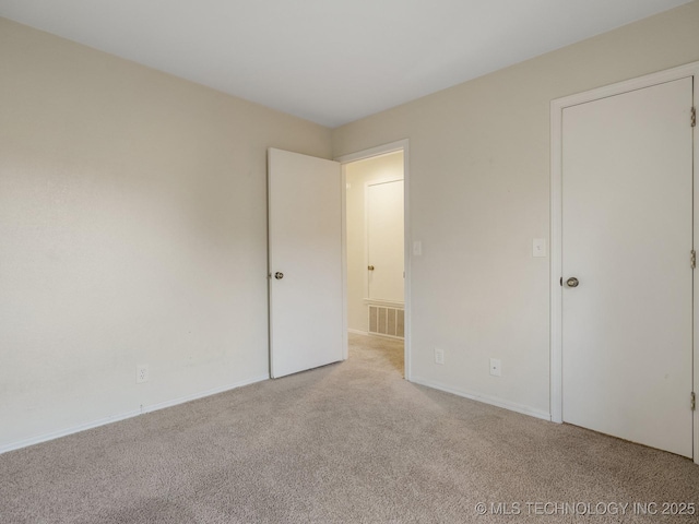 empty room featuring light colored carpet