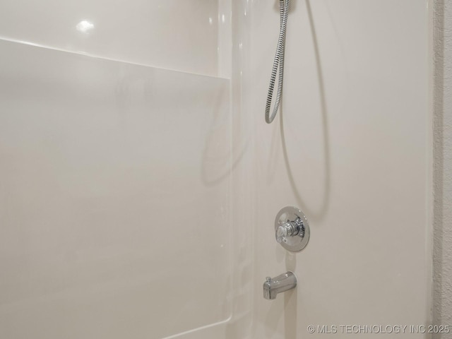 room details featuring shower / bath combination