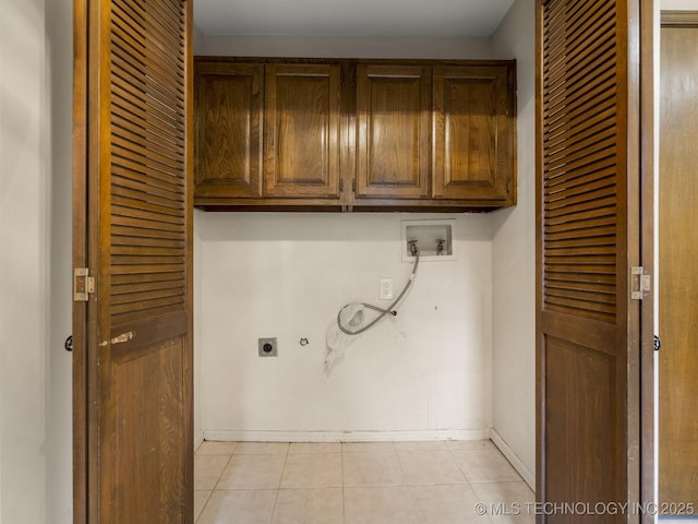 laundry area with cabinets, hookup for an electric dryer, hookup for a washing machine, and light tile patterned floors