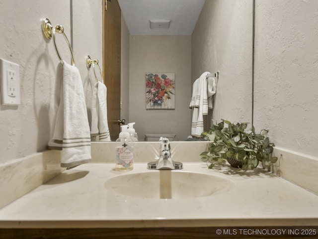 bathroom featuring toilet and vanity