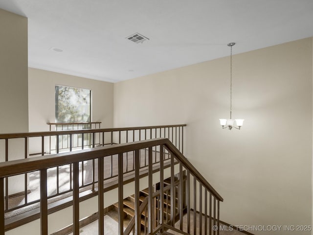 hallway with a notable chandelier