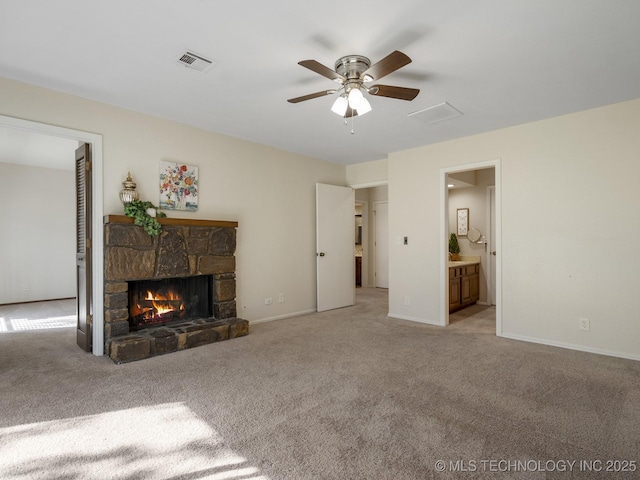 unfurnished living room with ceiling fan, light carpet, and a fireplace