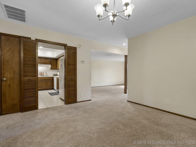 interior space with light colored carpet and a chandelier