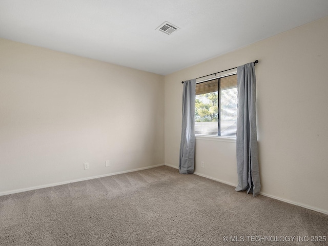 empty room with visible vents, carpet flooring, and baseboards