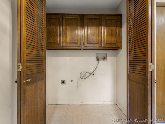 laundry area featuring cabinet space, electric dryer hookup, baseboards, and washer hookup