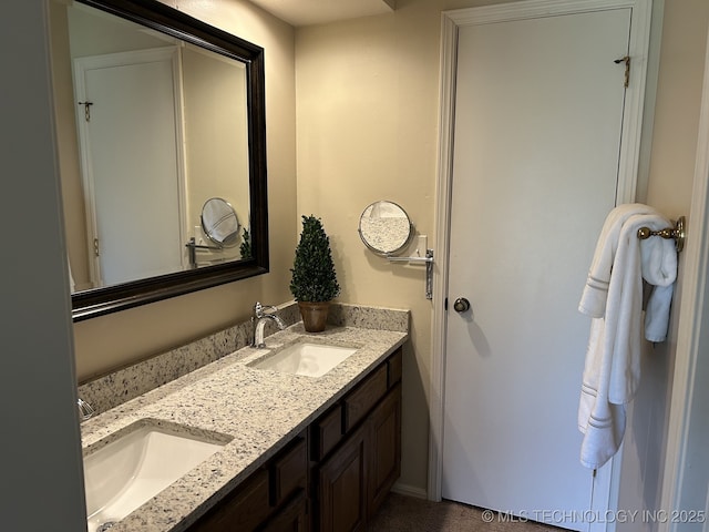 full bathroom with double vanity and a sink