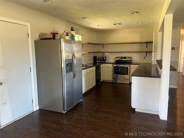 kitchen featuring backsplash, white cabinetry, stainless steel appliances, and dark hardwood / wood-style floors