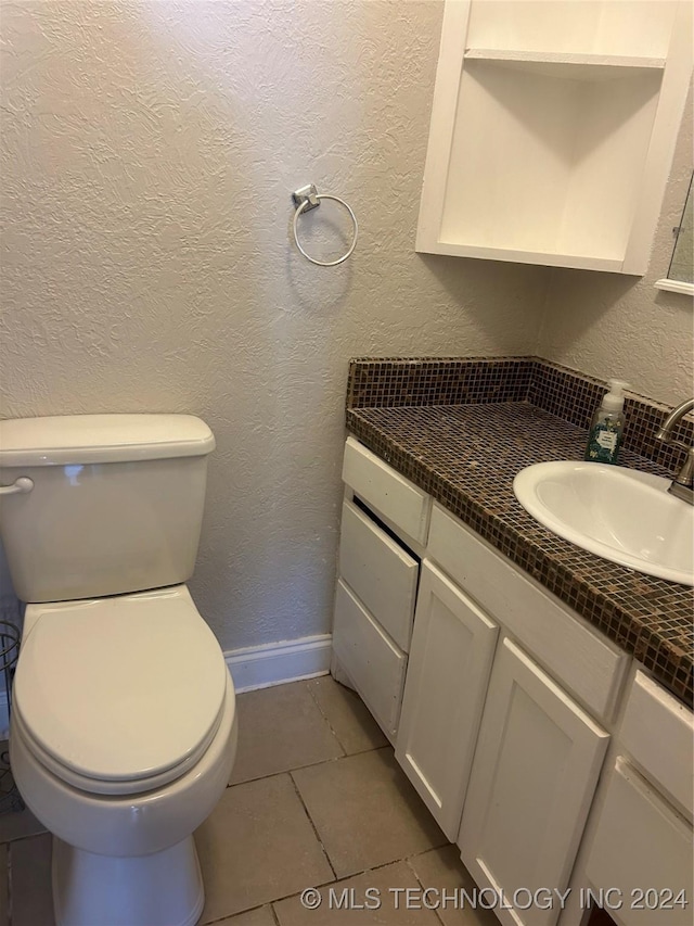 bathroom with tile patterned floors, vanity, and toilet