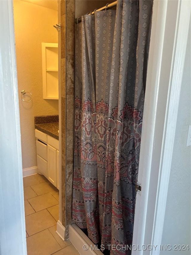 bathroom featuring tile patterned floors, a shower with curtain, and vanity