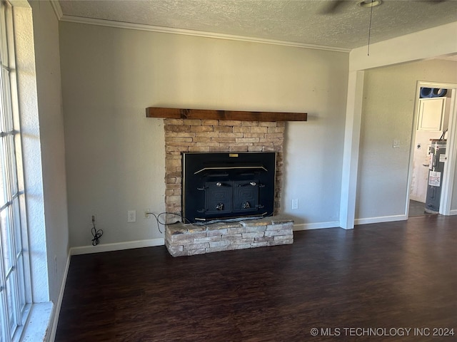 unfurnished living room with electric water heater, dark hardwood / wood-style floors, a wood stove, and ornamental molding