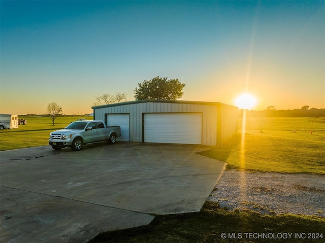 view of garage at dusk