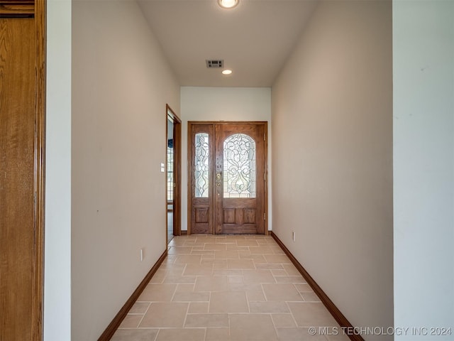 doorway to outside with light tile patterned floors