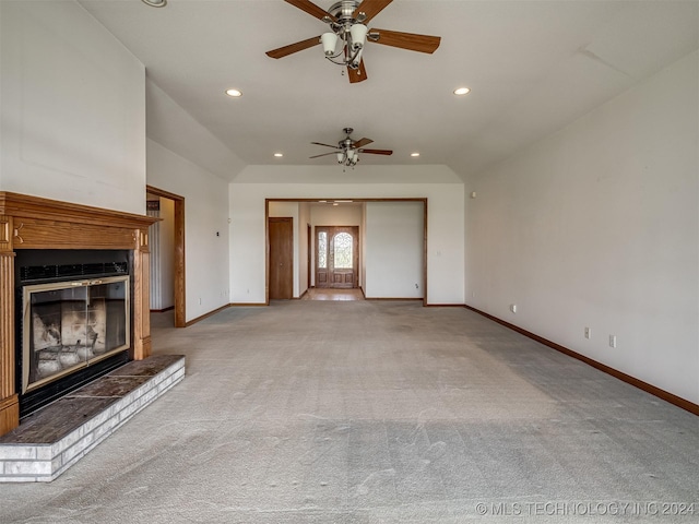 unfurnished living room with ceiling fan, light colored carpet, and vaulted ceiling