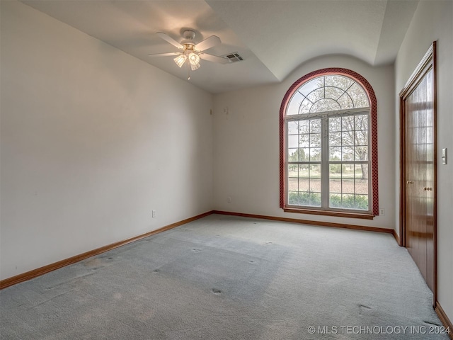 unfurnished room featuring ceiling fan, light carpet, and vaulted ceiling