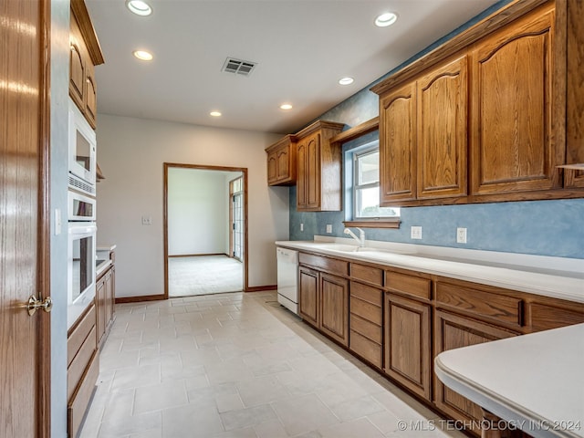 kitchen featuring sink and white appliances