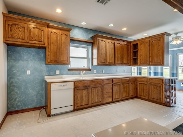 kitchen featuring light tile patterned floors, white dishwasher, ceiling fan, and sink