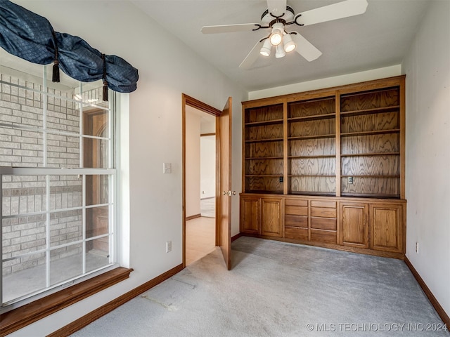 unfurnished bedroom featuring ceiling fan and light colored carpet