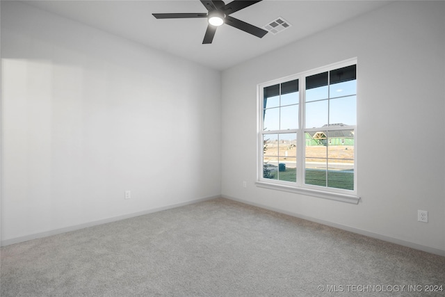 empty room with ceiling fan and carpet