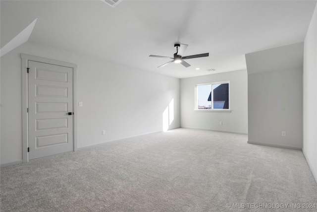 carpeted spare room with ceiling fan