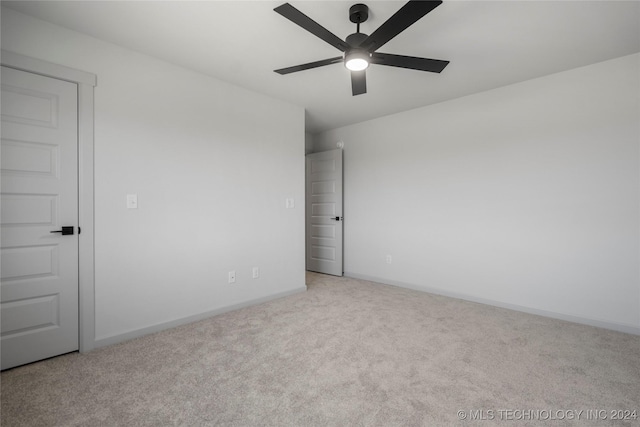 carpeted empty room with ceiling fan