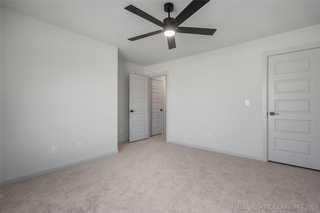 empty room with light colored carpet and ceiling fan