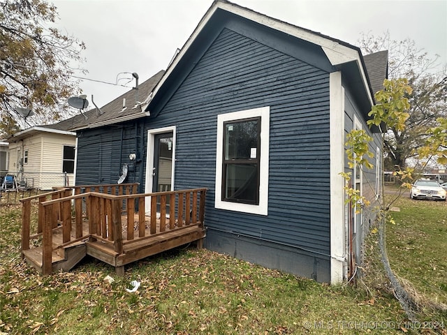 back of house with a yard and a wooden deck