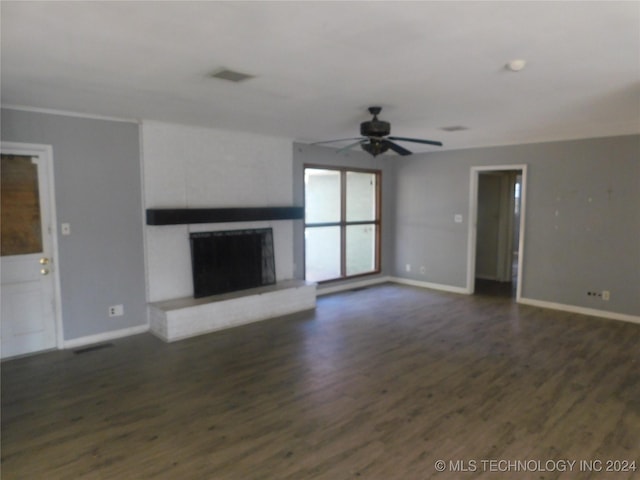 unfurnished living room with dark hardwood / wood-style flooring and ceiling fan