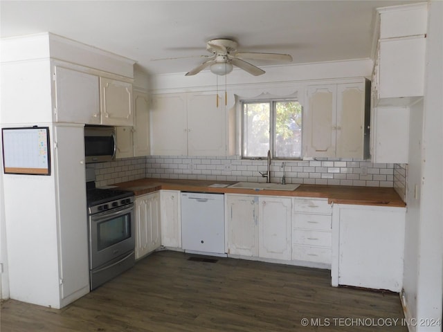 kitchen featuring ceiling fan, sink, stainless steel appliances, dark hardwood / wood-style floors, and white cabinets