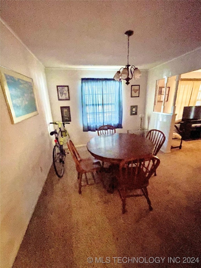 dining area featuring carpet flooring, a textured ceiling, and an inviting chandelier