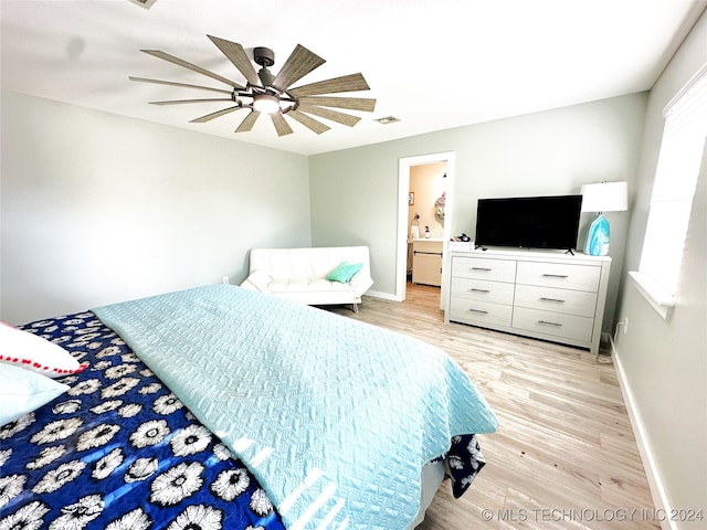 bedroom with ensuite bath, light hardwood / wood-style flooring, and ceiling fan