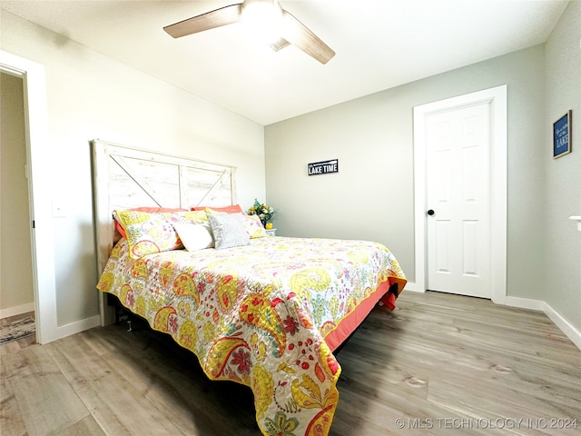 bedroom with ceiling fan and wood-type flooring