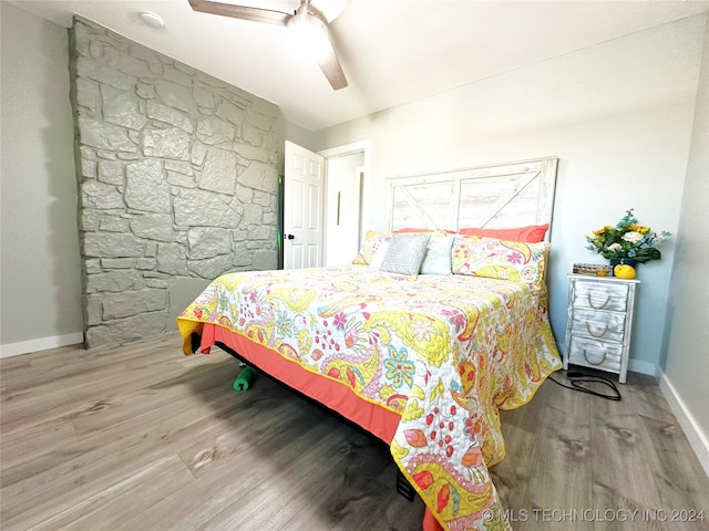 bedroom with ceiling fan and light hardwood / wood-style flooring