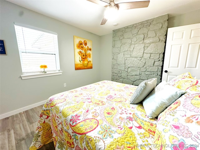 bedroom featuring ceiling fan and hardwood / wood-style flooring