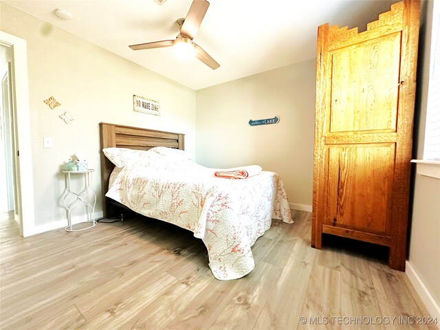 bedroom with ceiling fan and light hardwood / wood-style floors